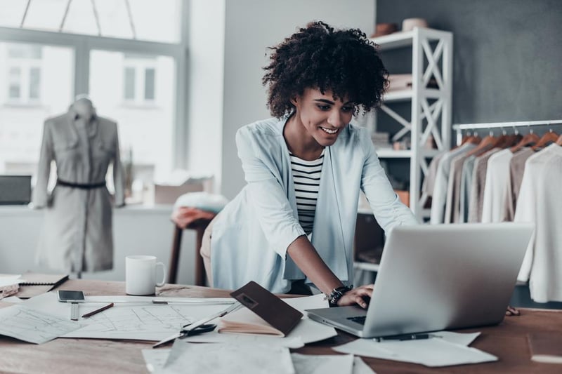 Entrepreneur using laptop to invoice customers