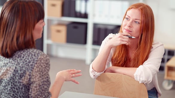 Two women discussing at a table